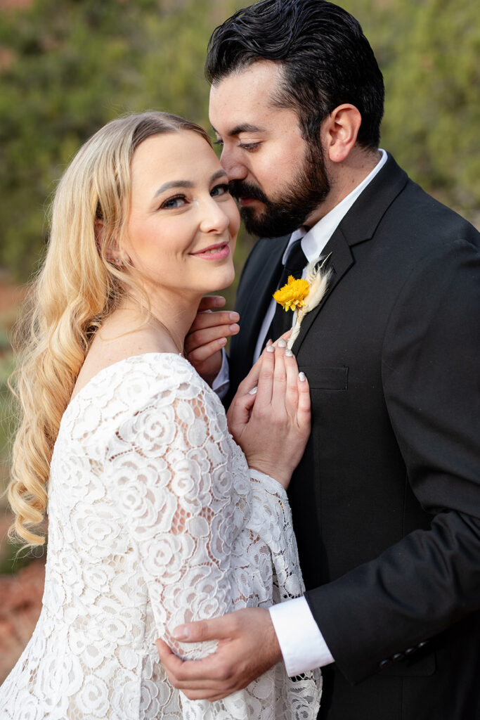 romantic close up elopement photography of the bride and groom hugging