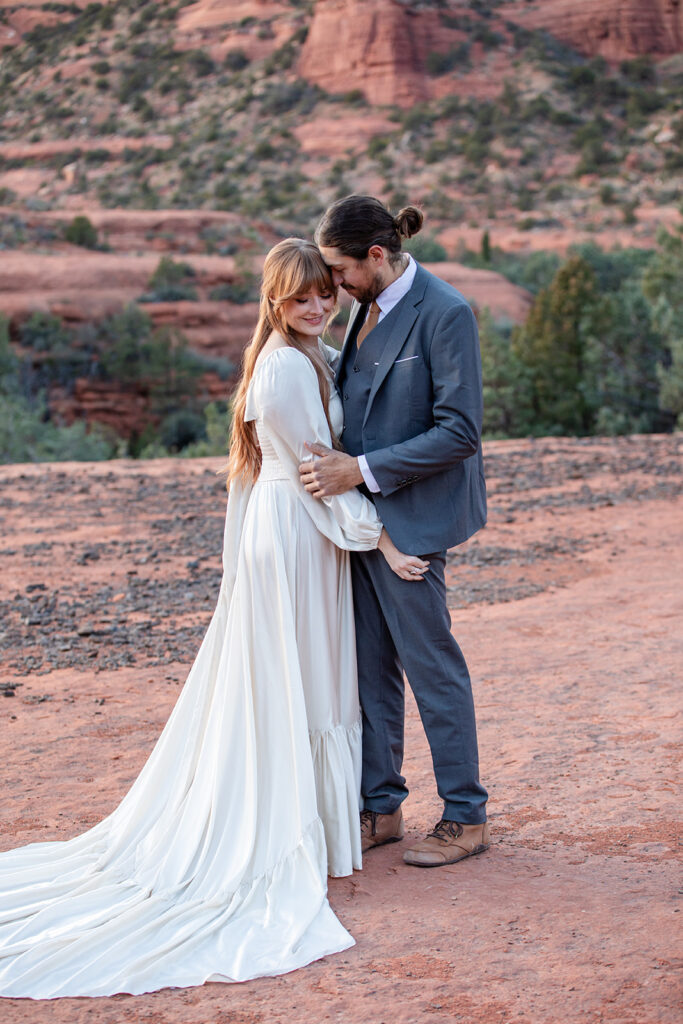 romantic elopement couple hugging during their winter elopement in sedona, arizona