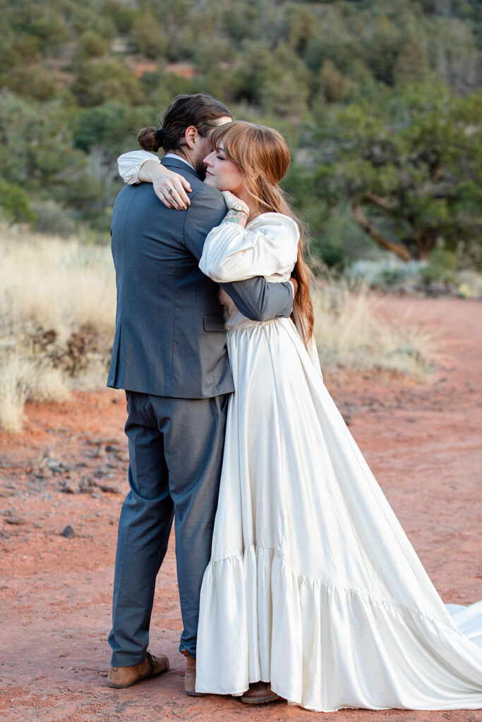 romantic elopement couple hugging during their winter elopement in sedona, arizona