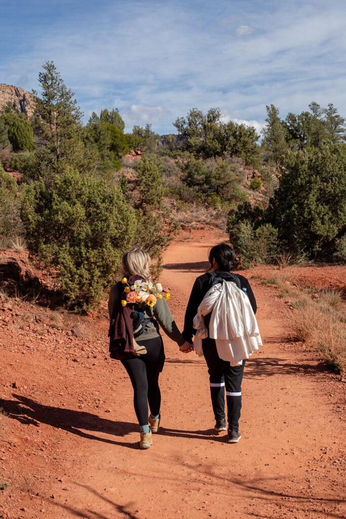 sweet couple going on a hike in sedona az to get to their elopement ceremony spot