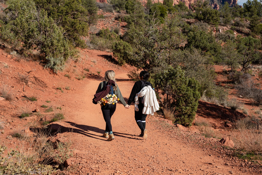 sweet couple going on a hike in sedona az to get to their elopement ceremony spot