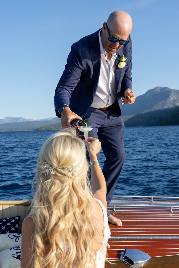 fun bride and groom photos in a classic boat on lake tahoe