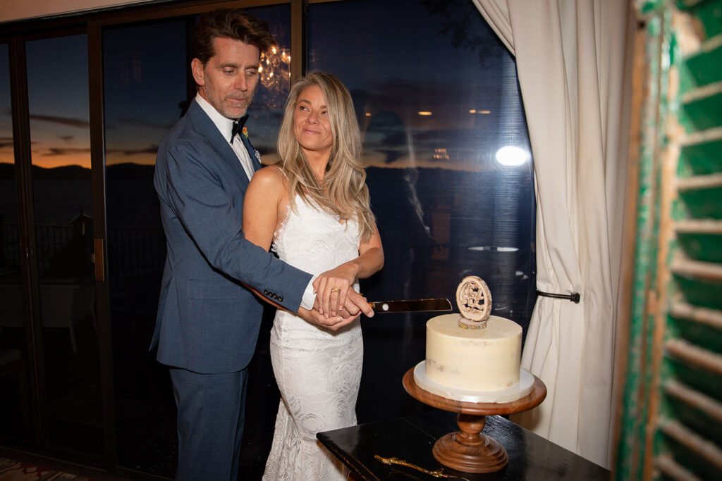 bride and groom cutting cake at their airbnb for their lake tahoe elopement