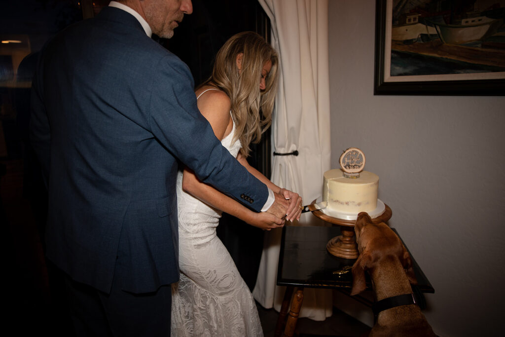 bride and groom cutting cake at their airbnb for their lake tahoe elopement