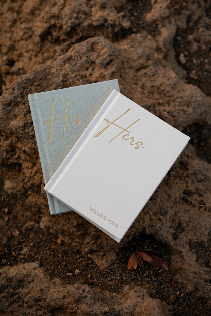 elegant vow books stacked on a rock