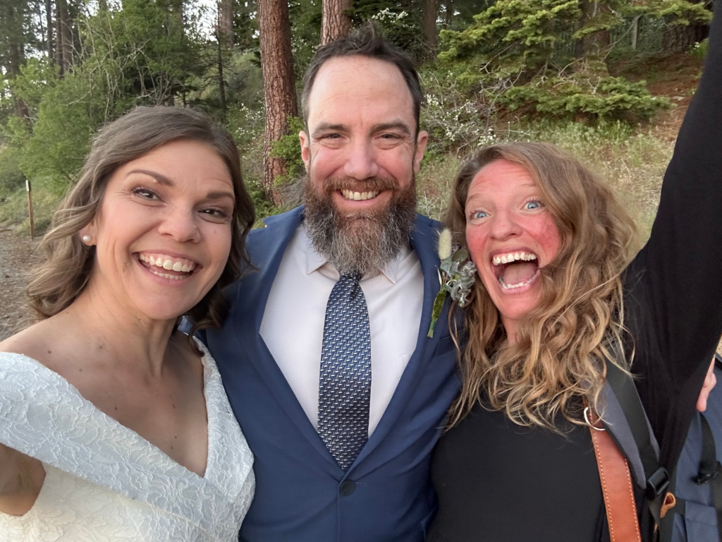 lake tahoe elopement planner and photographer posing with the couple during the elopement day