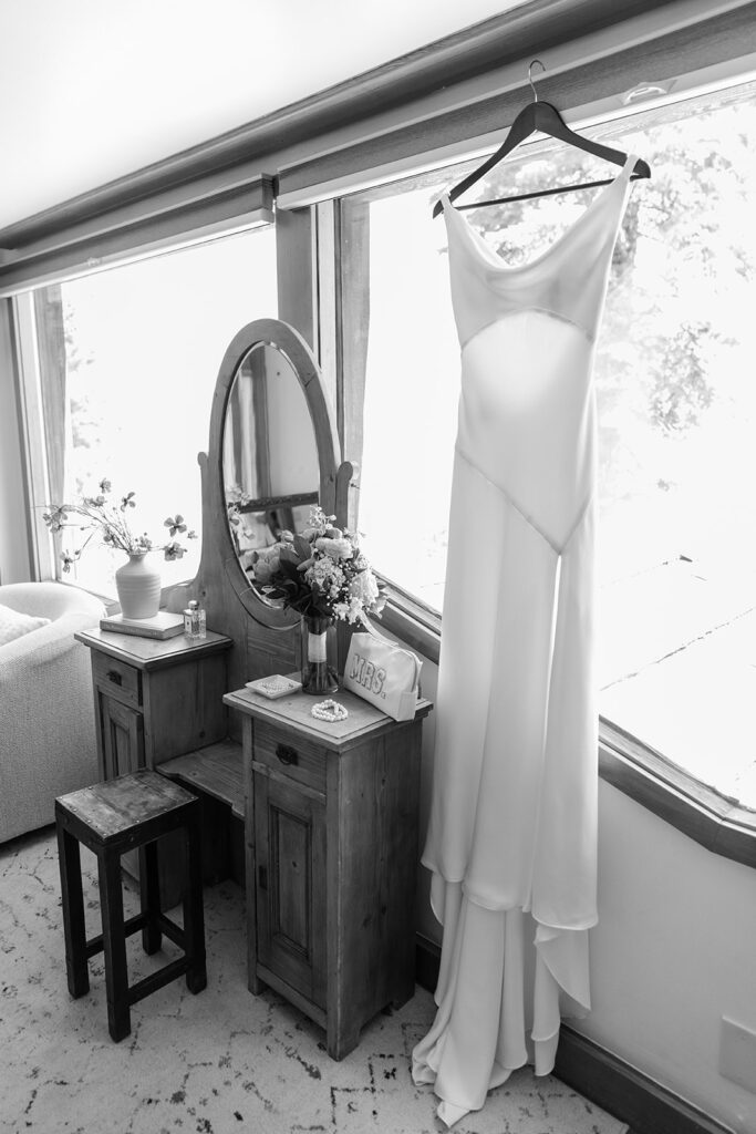 wedding dress hanging by a window