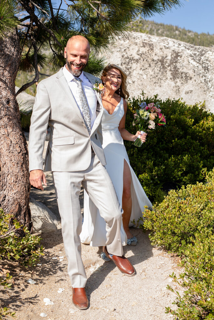 bride and groom walking towards their lake tahoe ceremony location