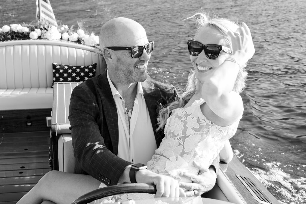 fun bride and groom steering a boat