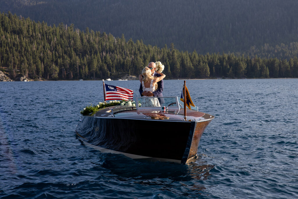 bride and groom kissing on a classic boat during their Lake Tahoe boat elopement