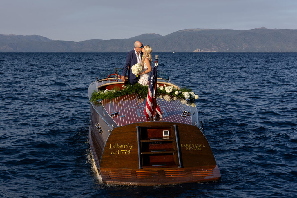 elopement couple enjoying themselves on a classic boat surrounded by Lake Tahoe landscapes