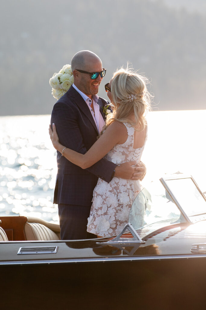 bride and groom kissing on a classic boat during their Lake Tahoe boat elopement