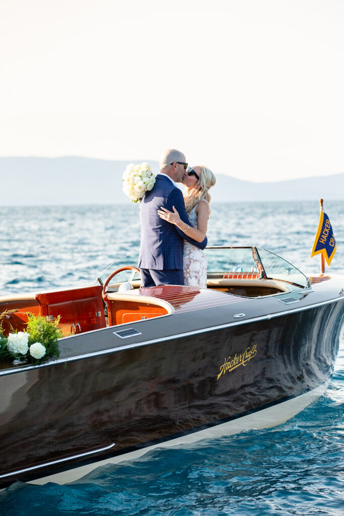 elopement couple enjoying themselves on a classic boat surrounded by Lake Tahoe landscapes