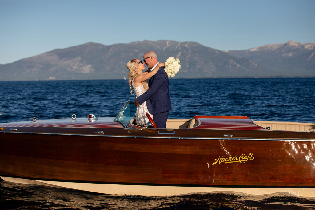 bride and groom kissing on a classic boat during their Lake Tahoe boat elopement