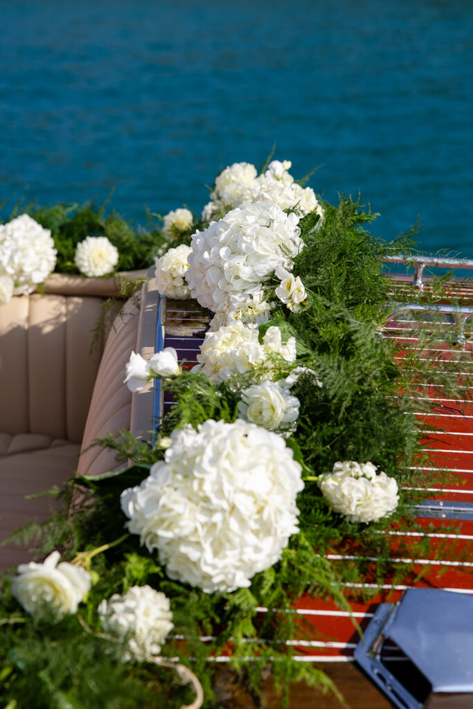 boat decor of white flowers and lush greens