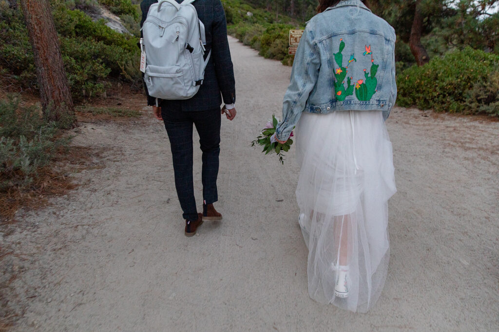 elopement couple hiking to their monkey rock elopement ceremony location