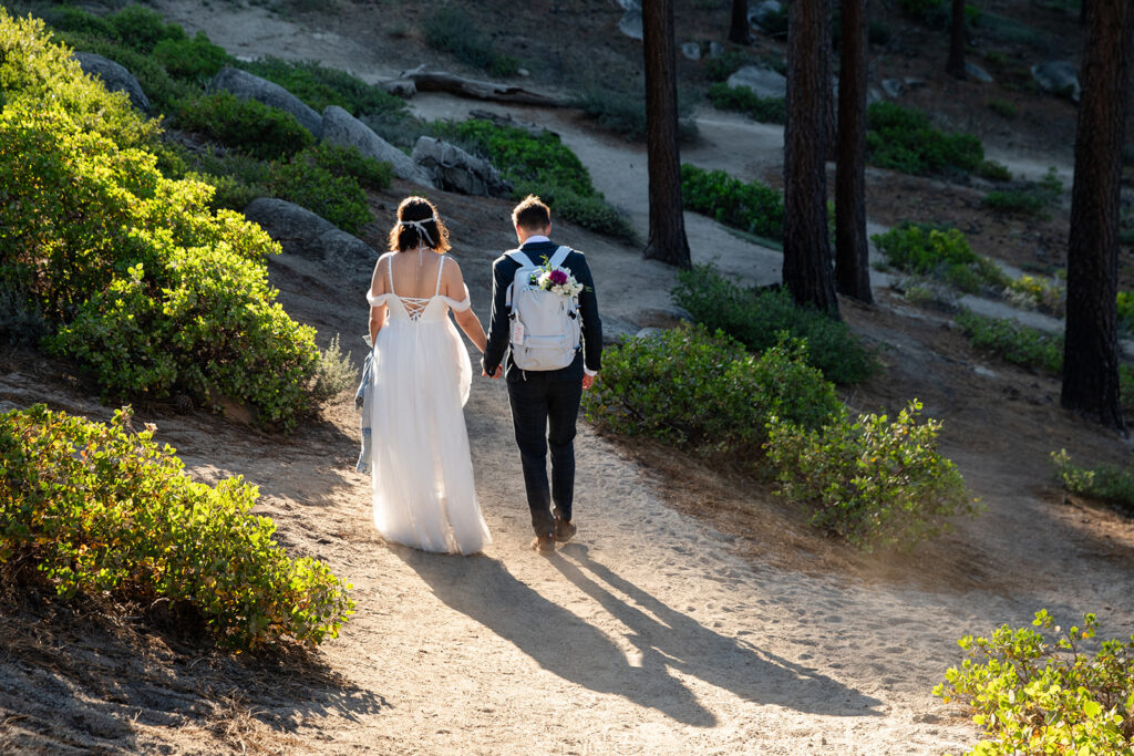 elopement couple hiking to hidden beach for their portraits