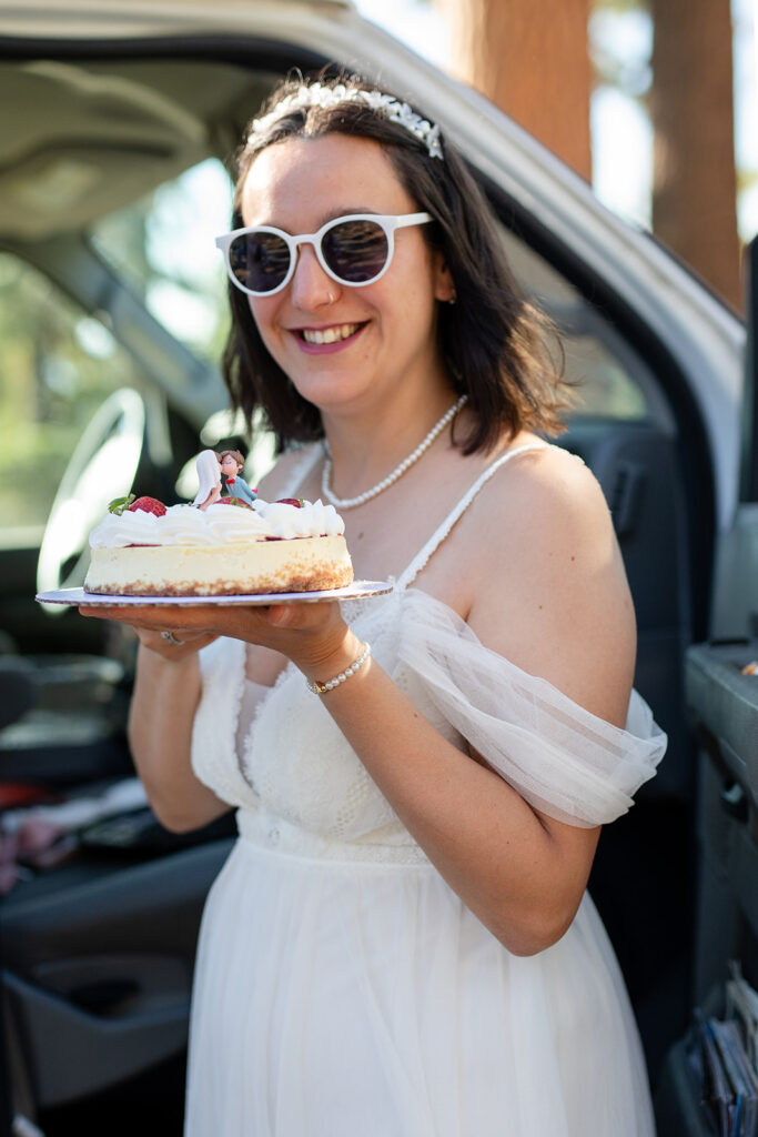 bride posing with a small elopement cake