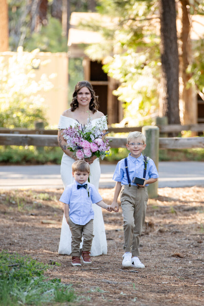 bride and her little sons walking down the aisle