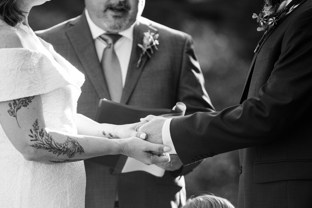 elopement couple holding hands during their elopement ceremony in skylandia park, tahoe