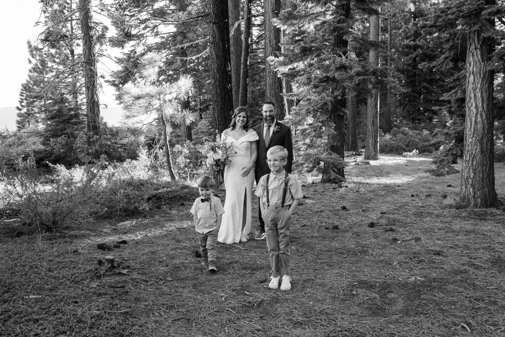 bride and groom and their little sons in the forest