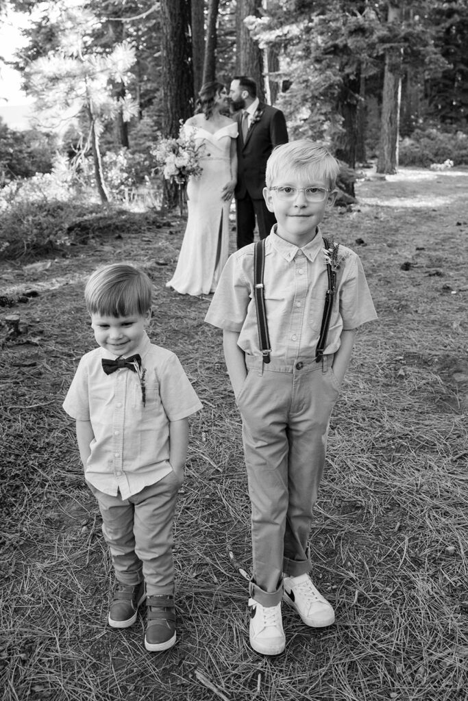 bride and groom and their little sons in the forest