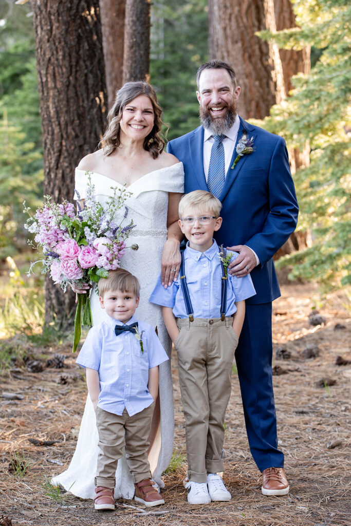 bride and groom and their little sons in the forest