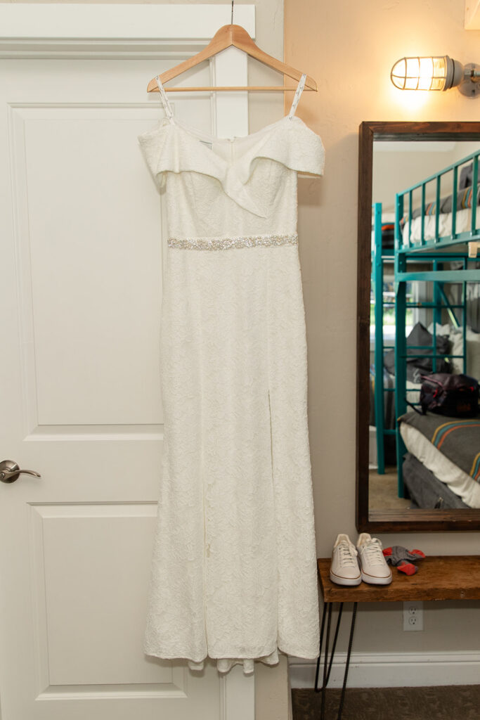 wedding dress hanging on a doorframe