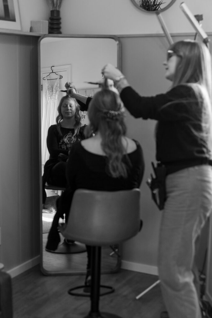 bride getting her hair and make up done at the airbnb