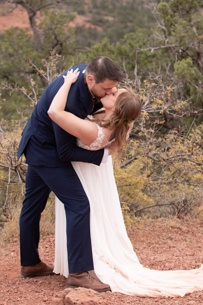 bride and groom sharing their first kiss