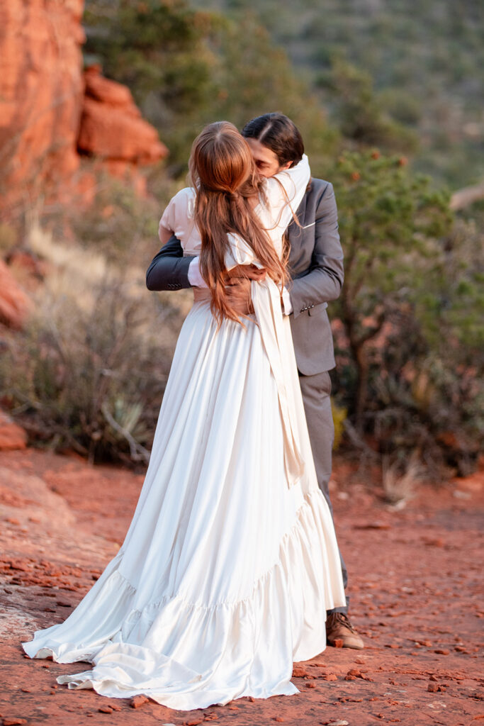 sweet elopement couple hugging and sharing an intimate moment together in Sedona