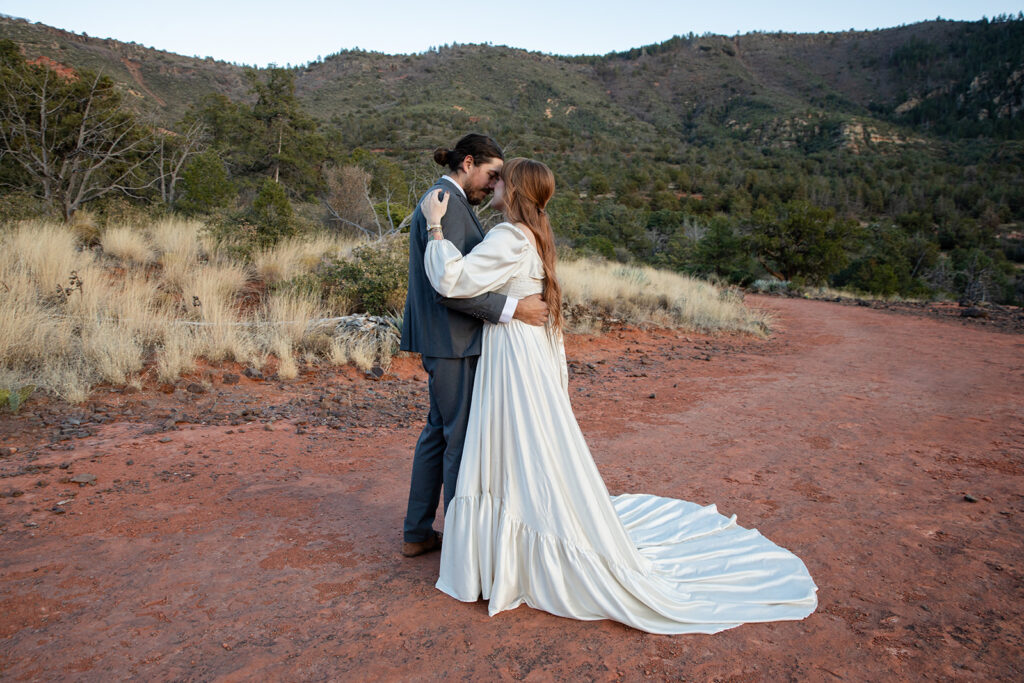 sweet elopement couple hugging and sharing an intimate moment together in Sedona