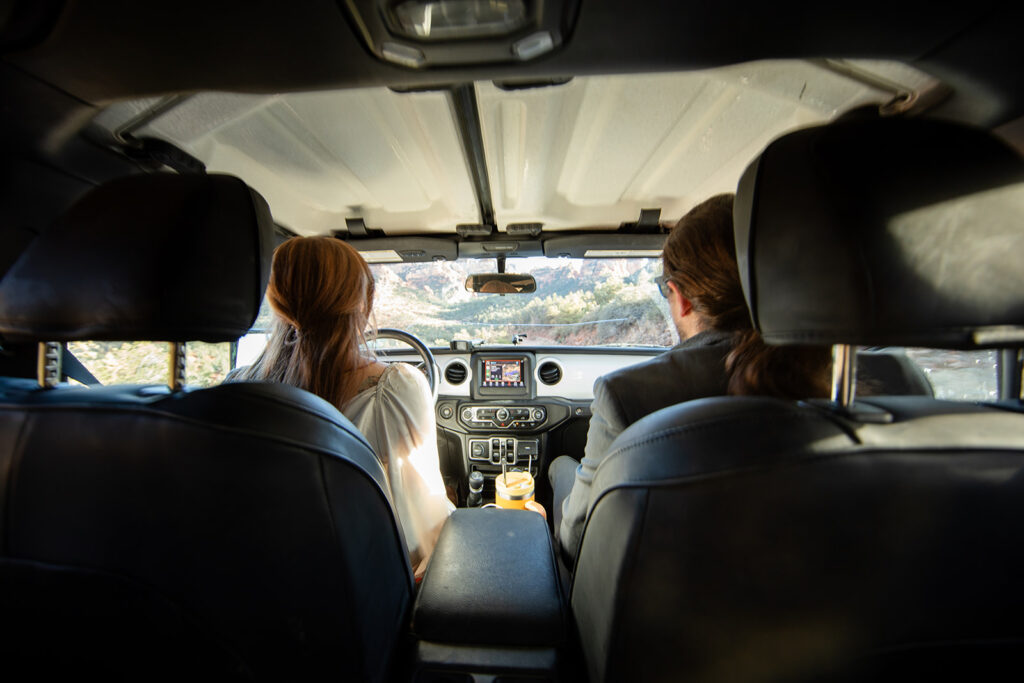 elopement couple in a 4x4 drive heading towards their vow renewal in sedona