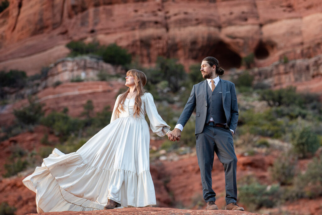 elopement couple surrounded by stunning landscapes of sedona az