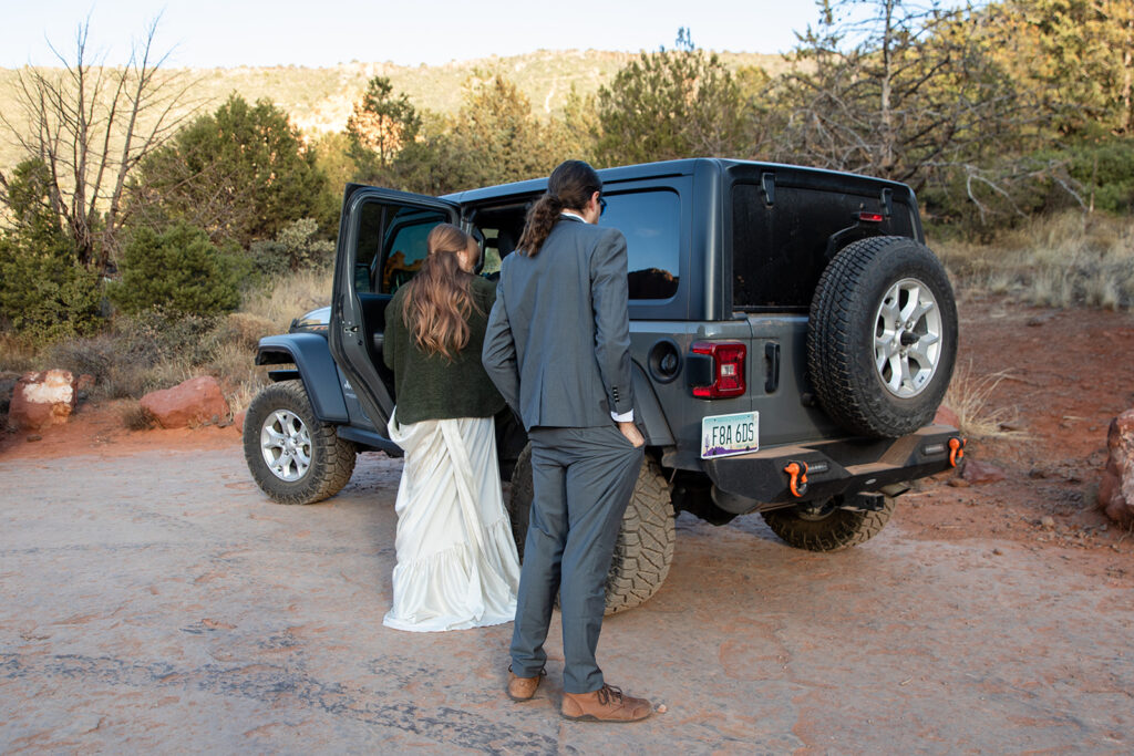 elopement couple in a 4x4 drive heading towards their vow renewal in sedona