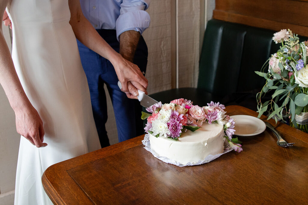 bride and groom cutting cake