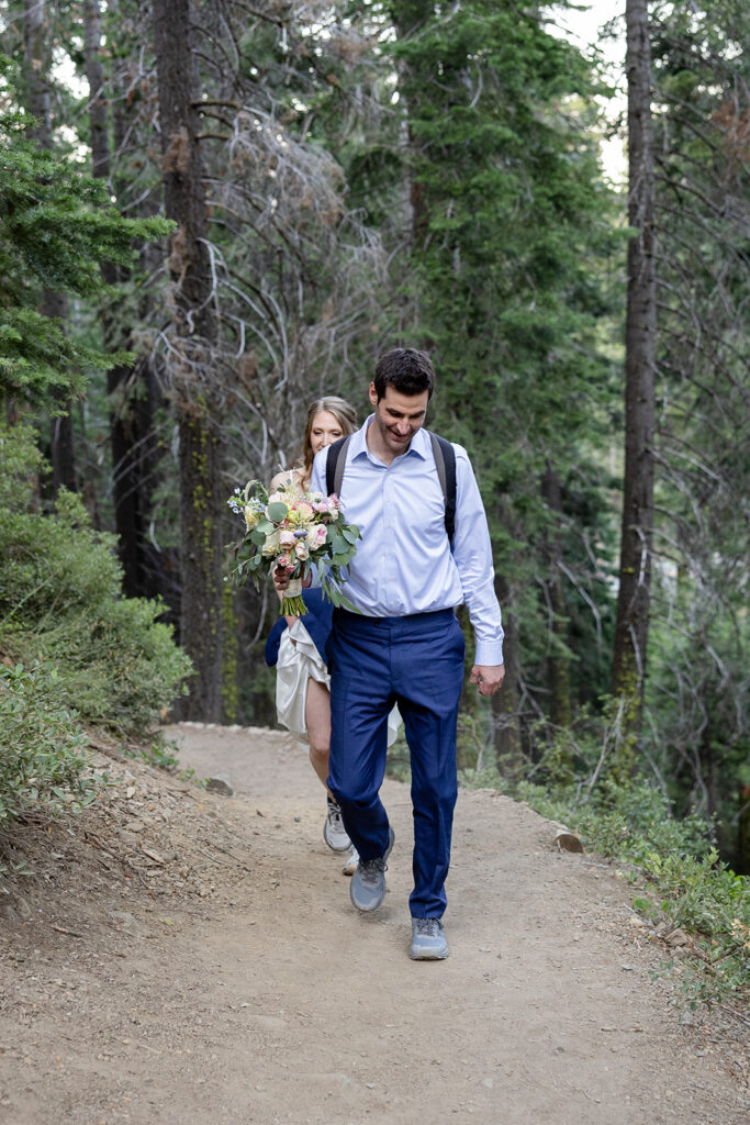 adventurous elopement couple hiking to a scenic overview