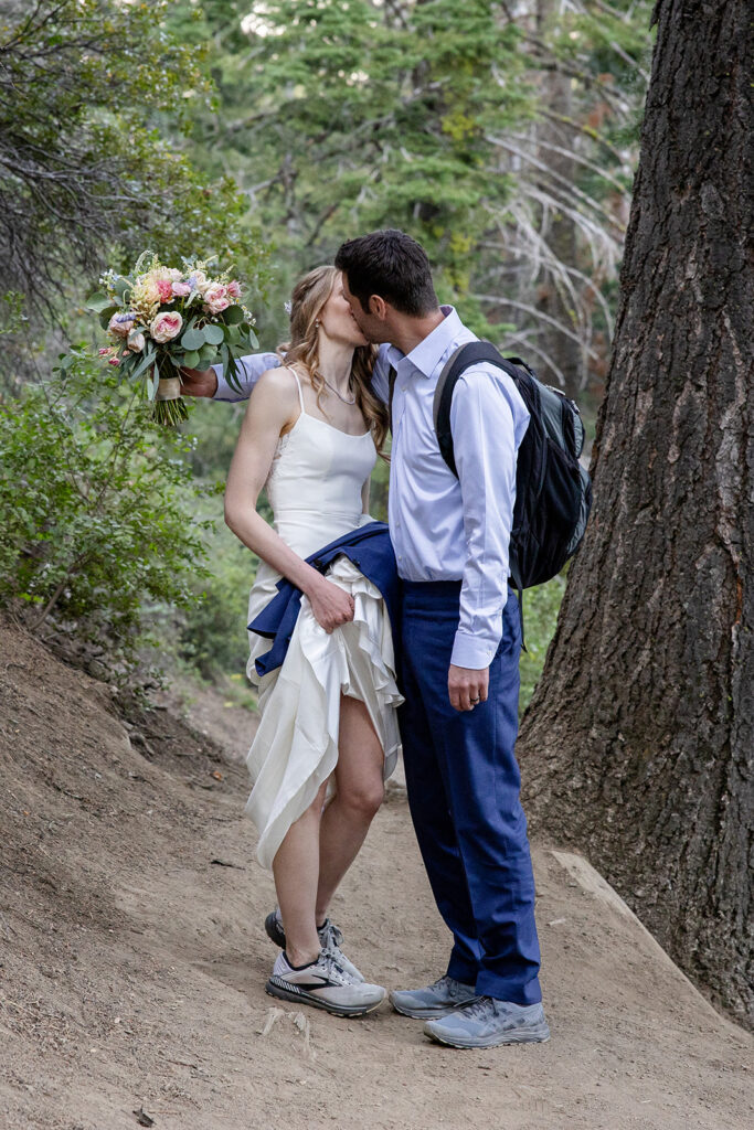 adventurous elopement couple hiking to a scenic overview