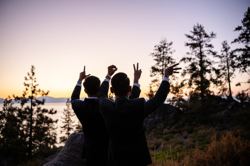 gay couple spelling out the word LOVE with their hands