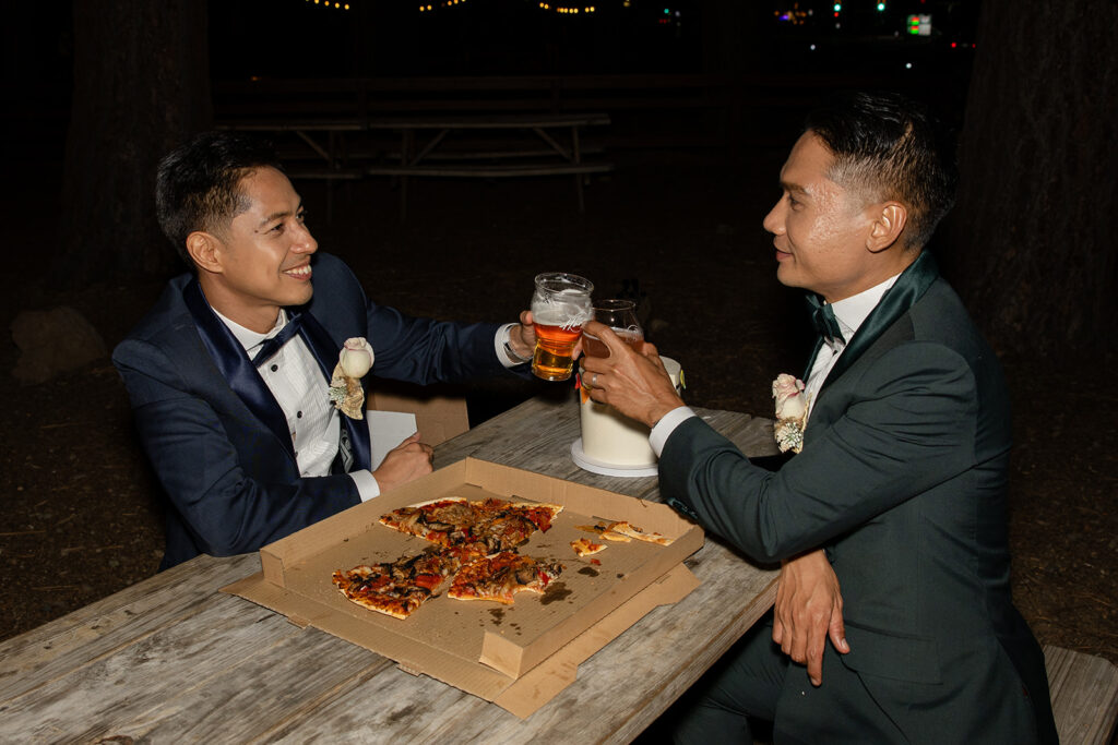 lgbtq elopement couple celebrating their day at a brewery with pizza