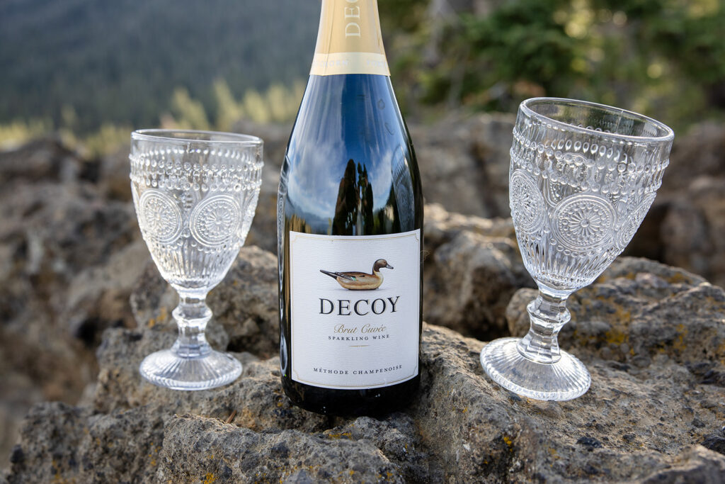 bride and groom enjoying a glass of champagne together during their simple elopement day at lake tahoe