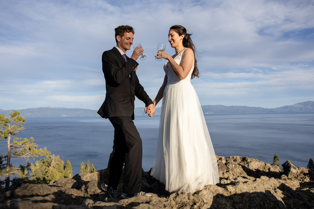 bride and groom enjoying a glass of champagne together during their simple elopement day at lake tahoe