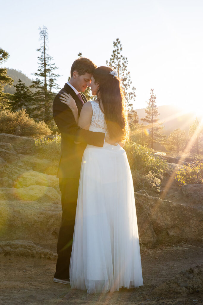 elopement couple in an embrace with golden hour light surrounding them