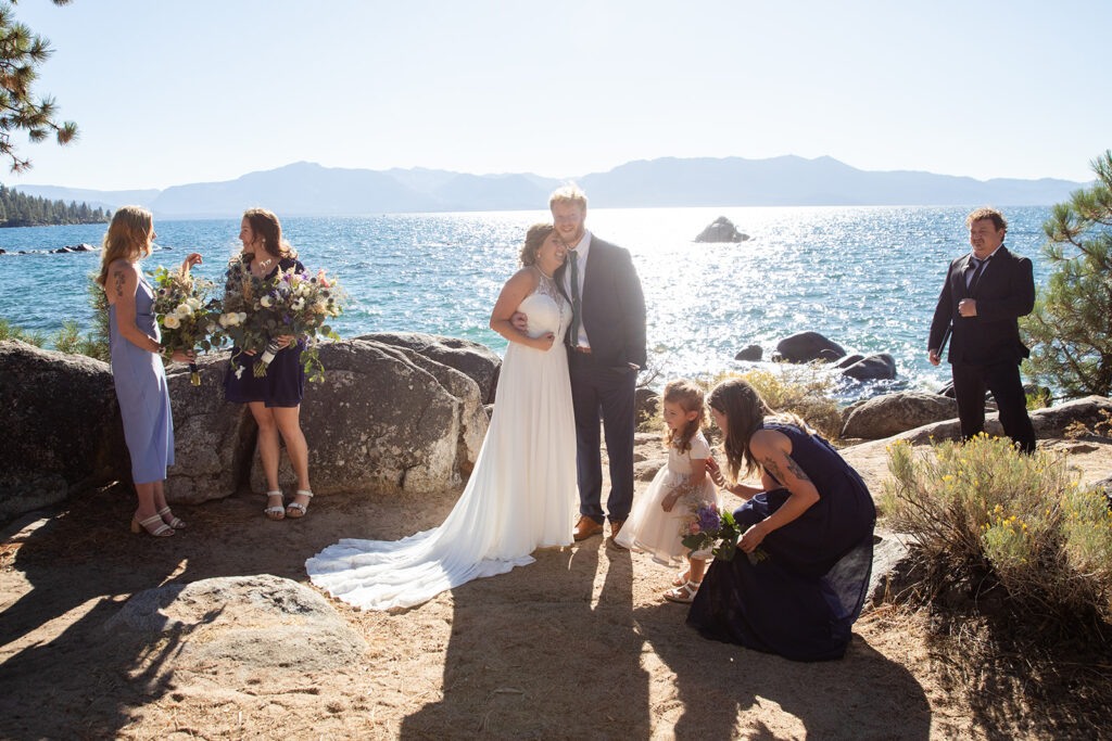 bride and groom hugging surrounded by their loved ones