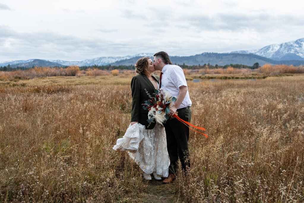 boho elopement couple south lake tahoe elopement in a meadow with mountain backdrops