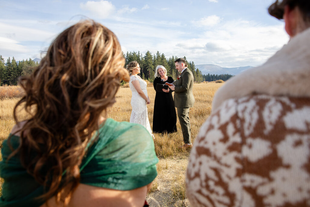 south lake tahoe elopement ceremony in a meadow with forest and mountain views in the backdrop