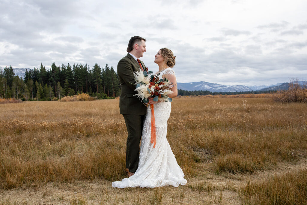 boho elopement couple south lake tahoe elopement in a meadow with mountain backdrops