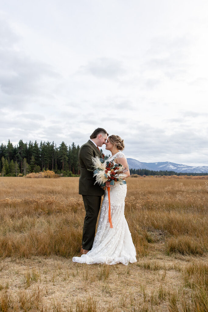 boho elopement couple south lake tahoe elopement in a meadow with mountain backdrops