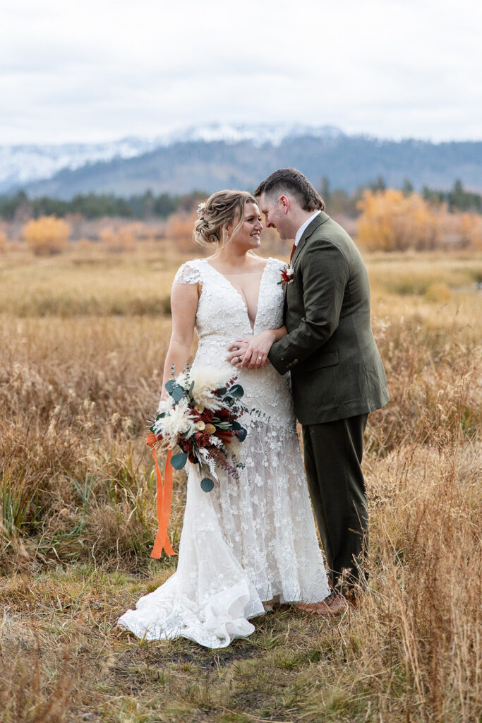 boho elopement couple south lake tahoe elopement in a meadow with mountain backdrops